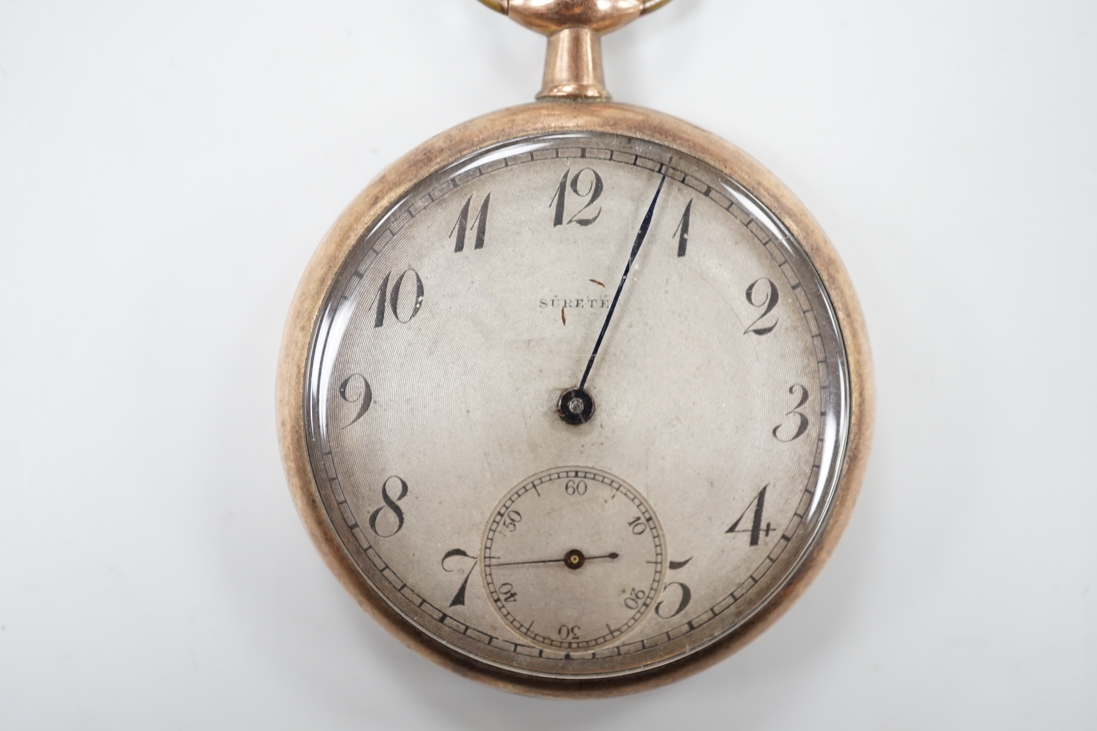 A yellow metal open faced keyless pocket watch, the Arabic dial with subsidiary seconds and inscribed 'Surete', (a.f.).